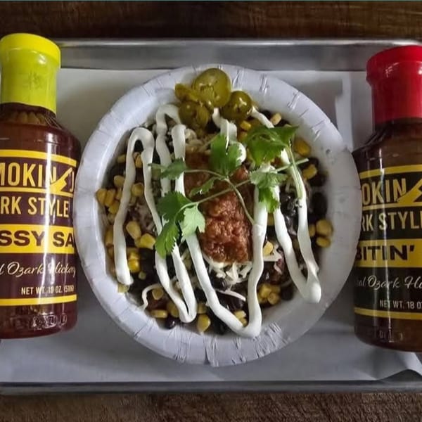 Smokin' Jones BBQ bowl with corn, black beans, cheese, salsa, sour cream, cilantro, and jalapeños.